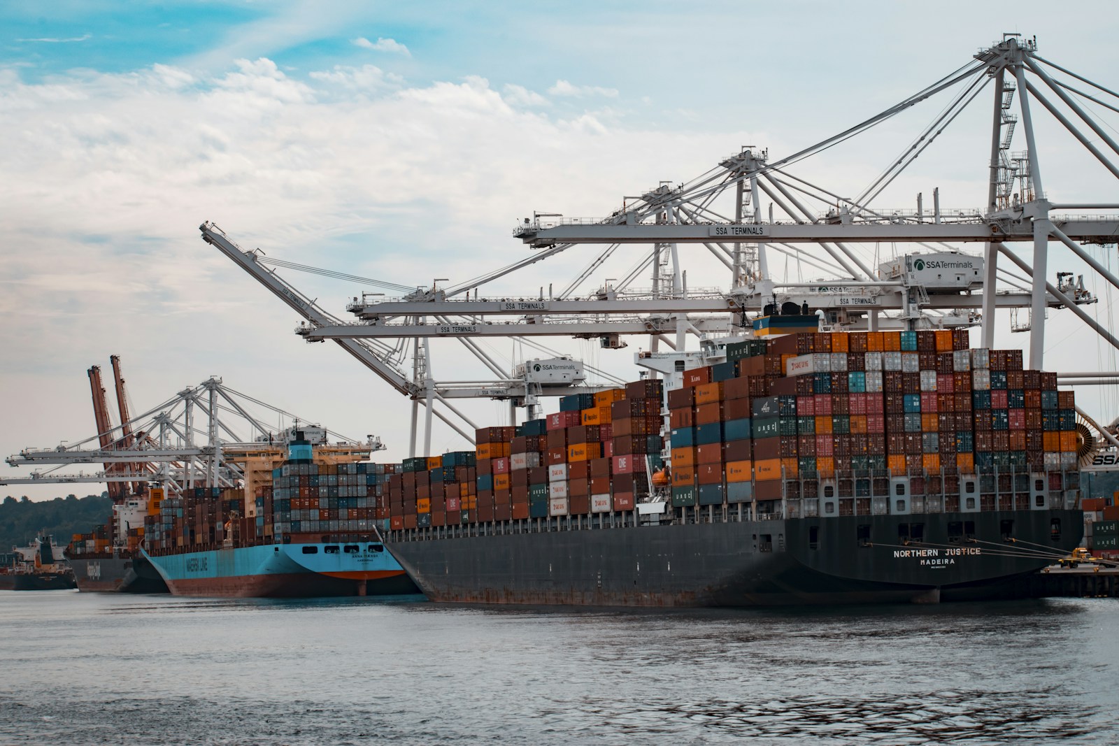 Shipping containers and cranes at a commercial port.